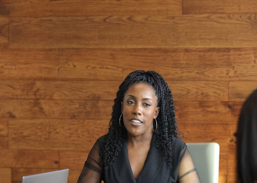 Mesia Crews seated at a table in conversation